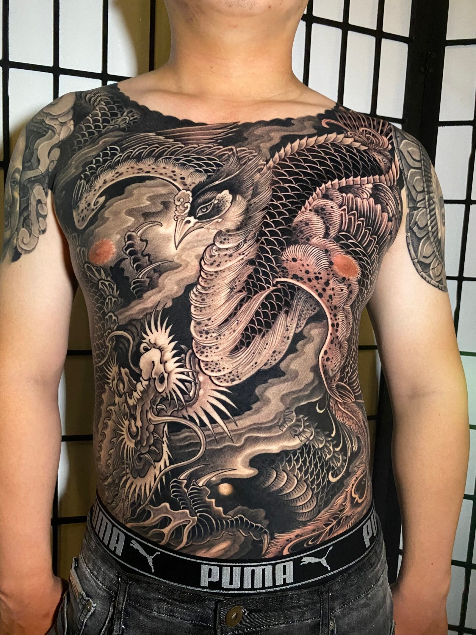 Asian blackwork upper back tattoo by Thuong Nguyen at Overthink-Ink Saigon