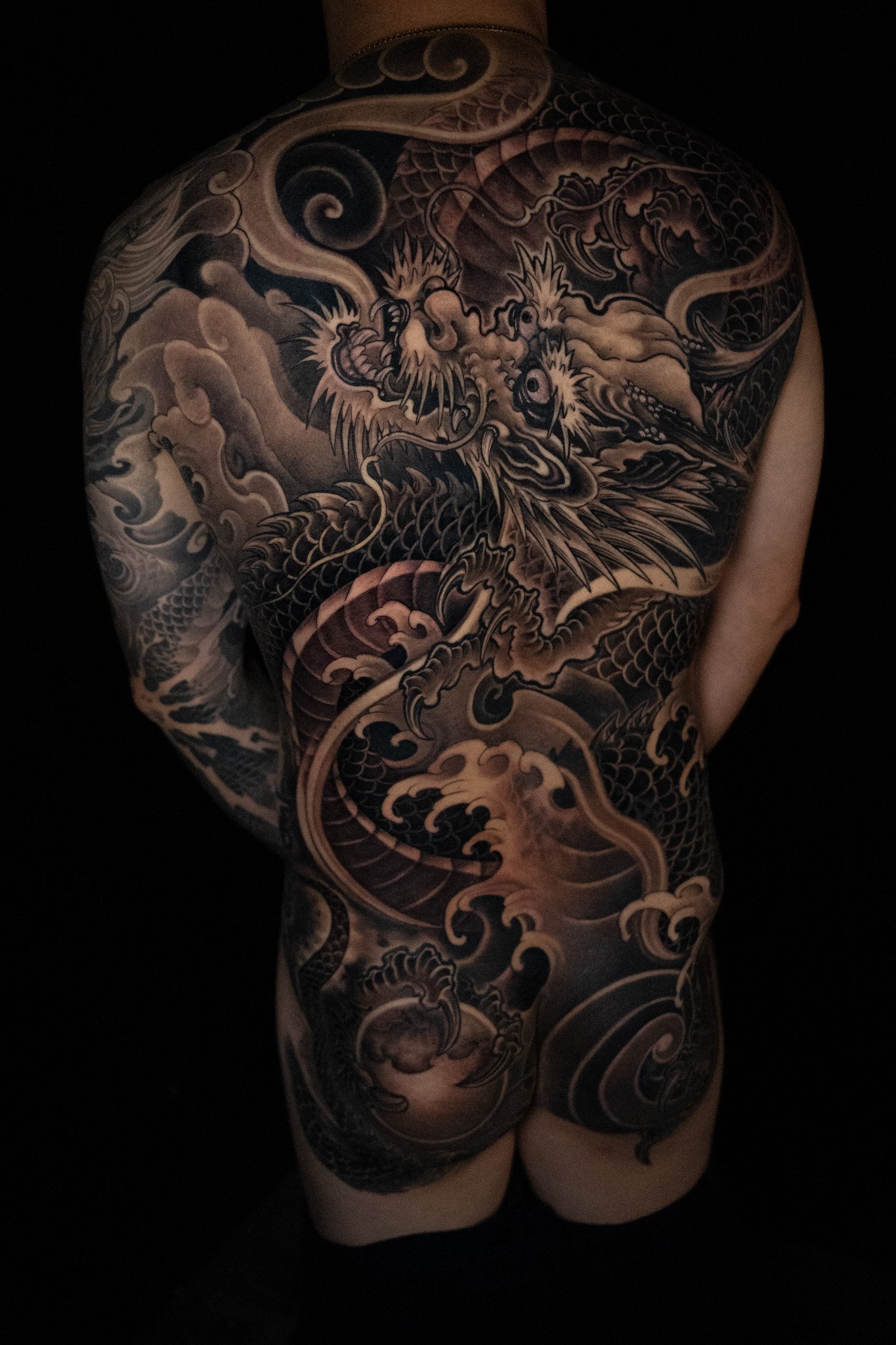 Asian blackwork upper back tattoo by Thuong Nguyen at Overthink-Ink Saigon